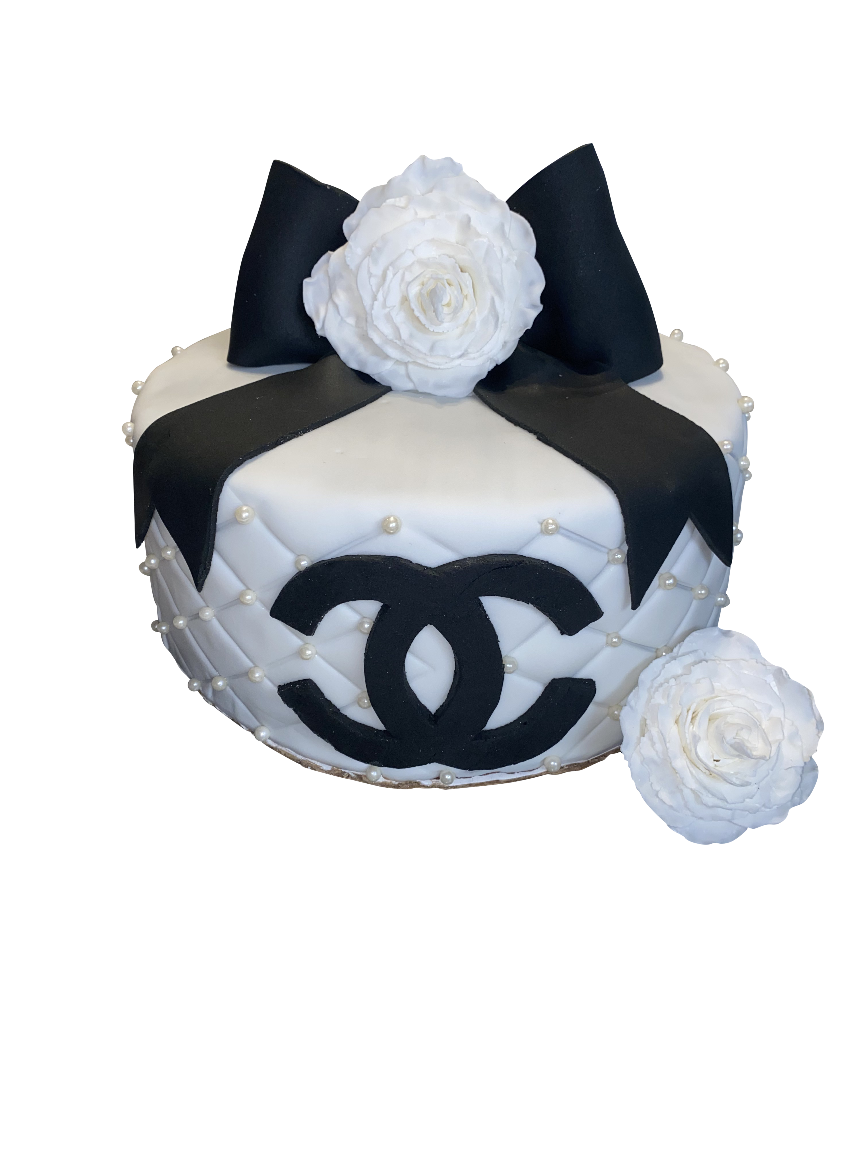 Chanel inspired birthday cake in the shape of a purse at a